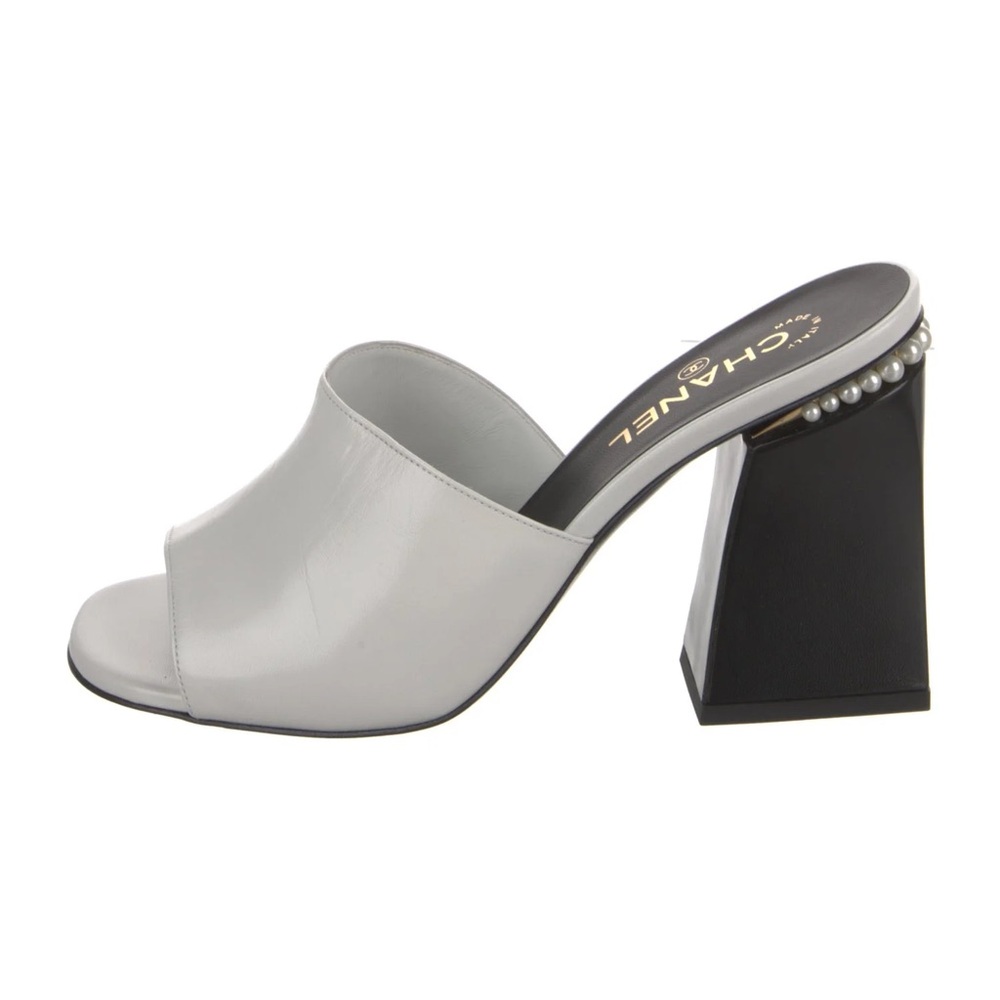 CHANEL Elegant White and Black Mules with Pearl Detail